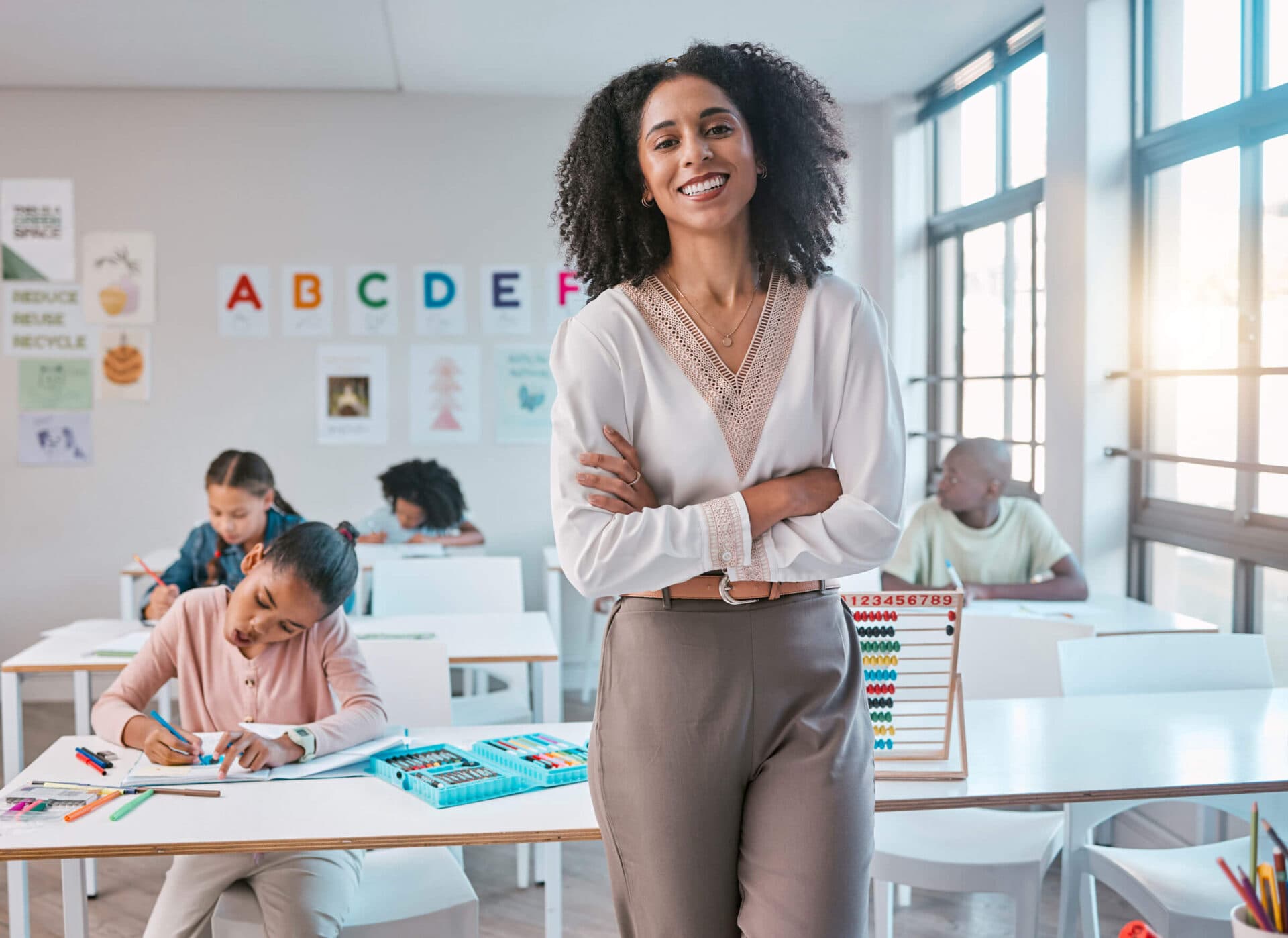 A Little Giants teacher standing in her classroom